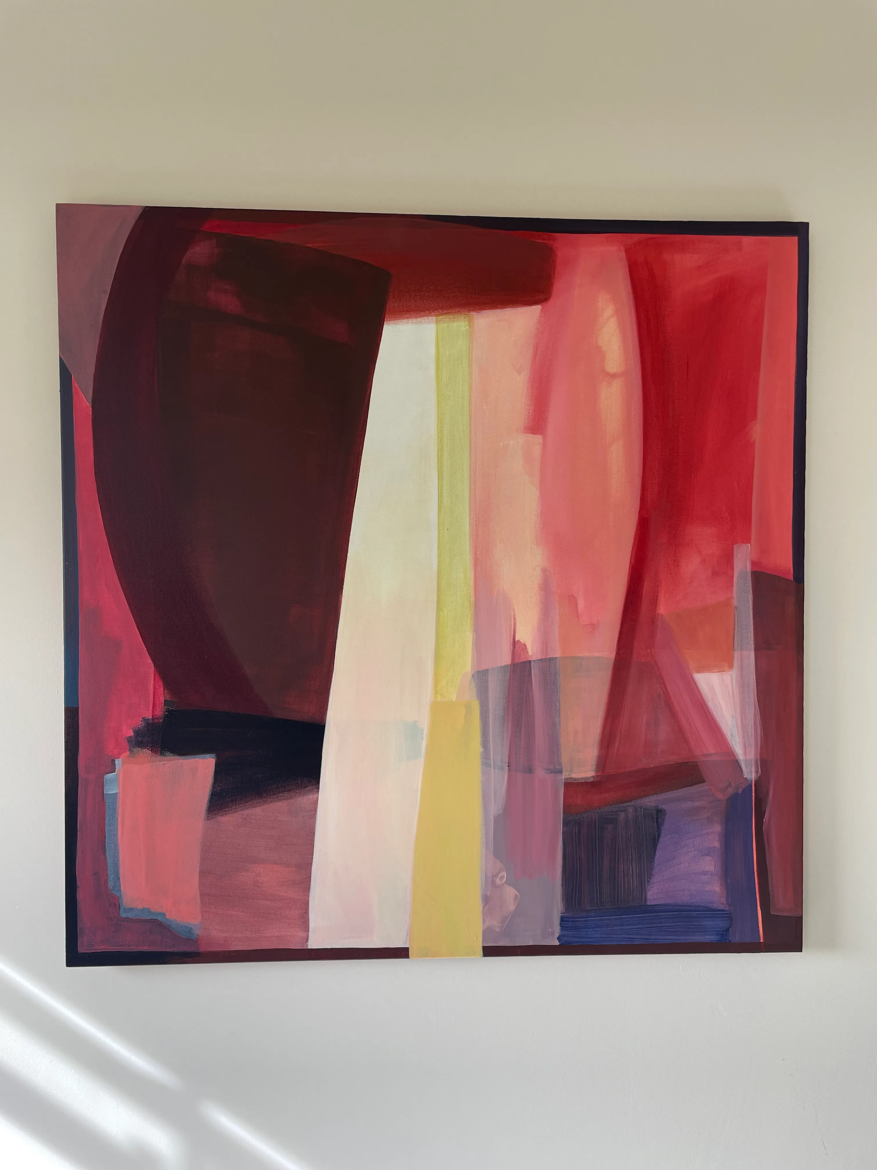 Abstract painting in deep reds and maroon with a pale yellow vertical band