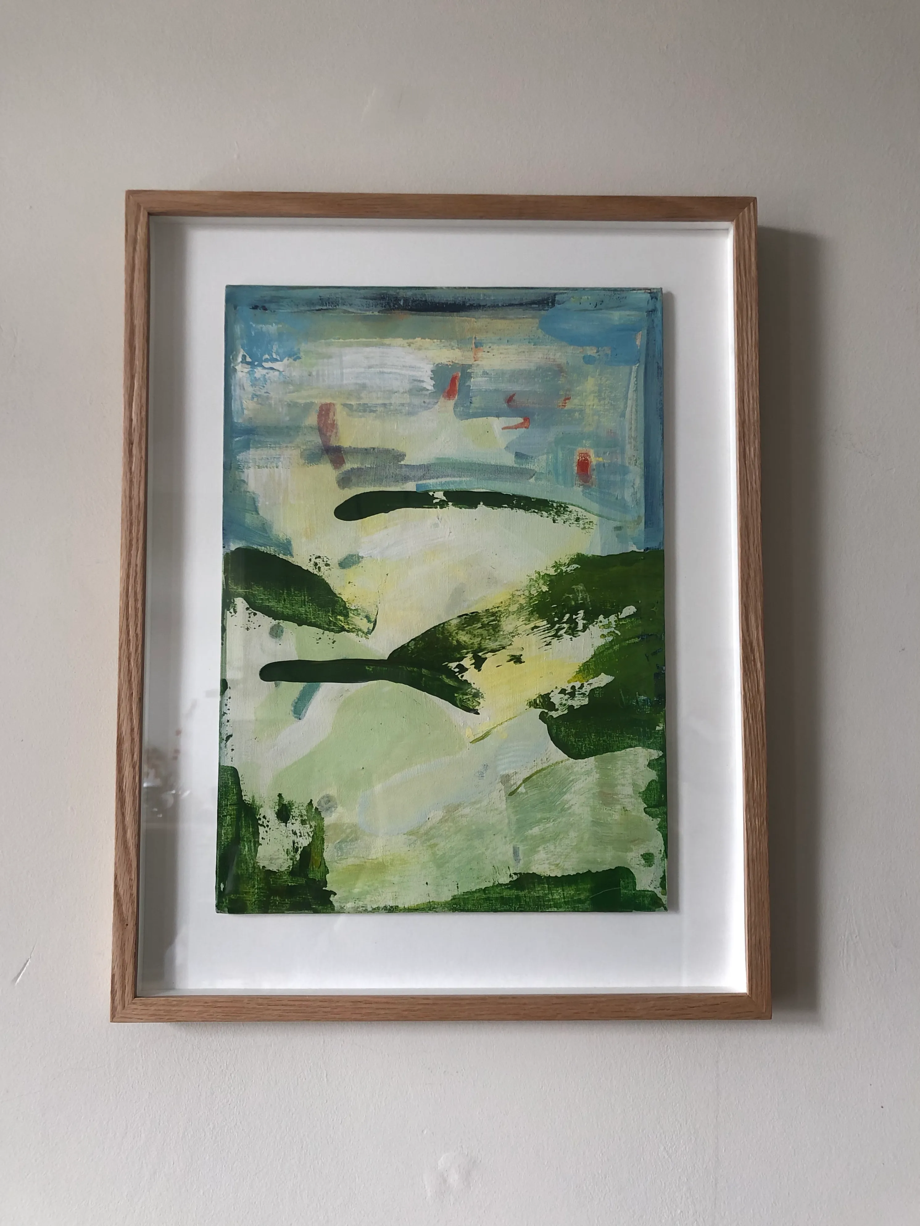 Framed abstract landscape in soft greens and blue