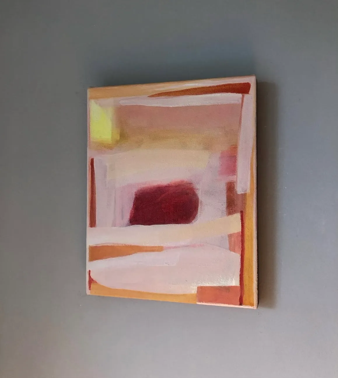 Small abstract canvas in pinks with a deep maroon block and ochre edges