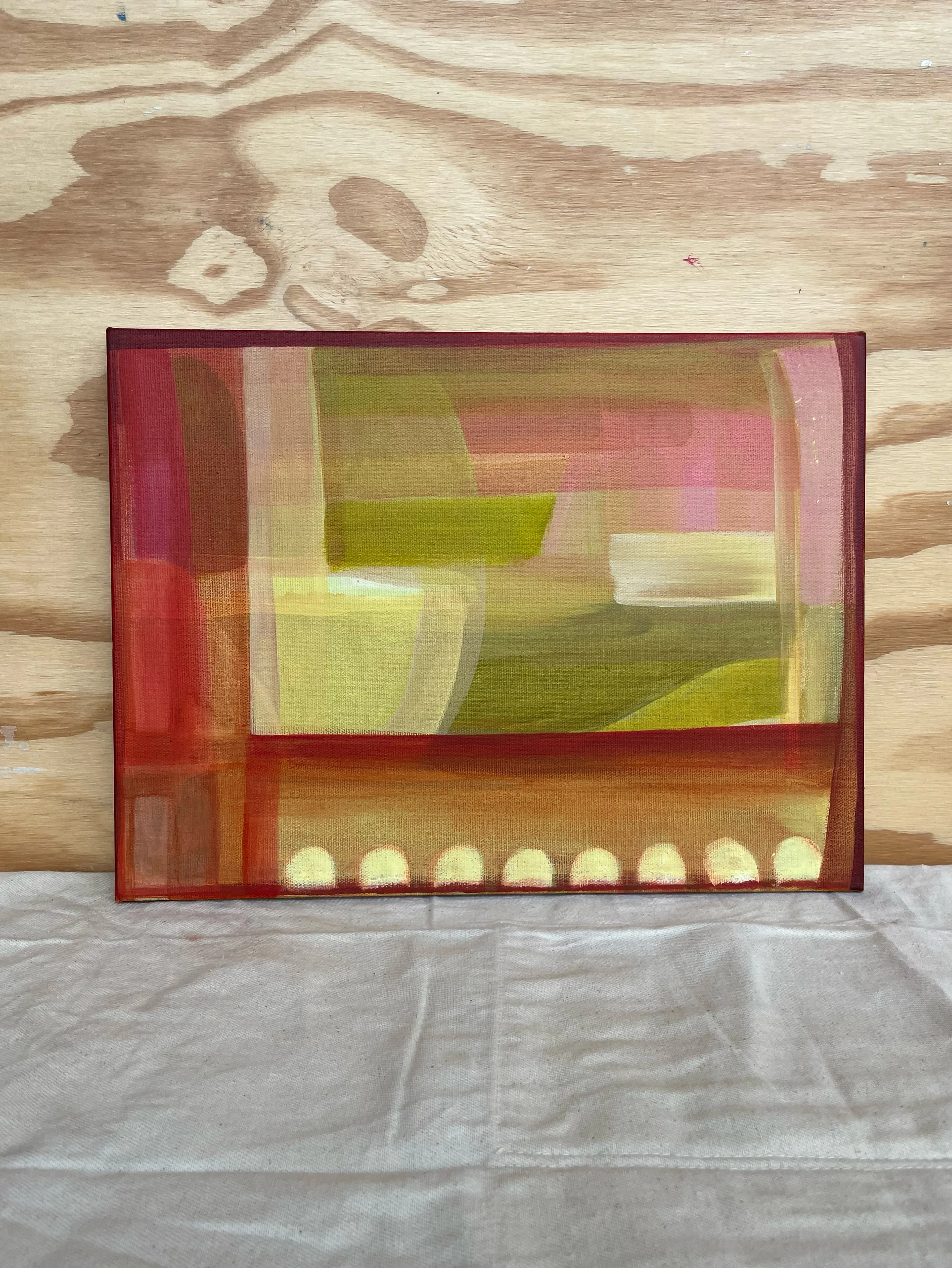 Warm abstract painting in pinks, greens and yellow with a row of pale marks along the base